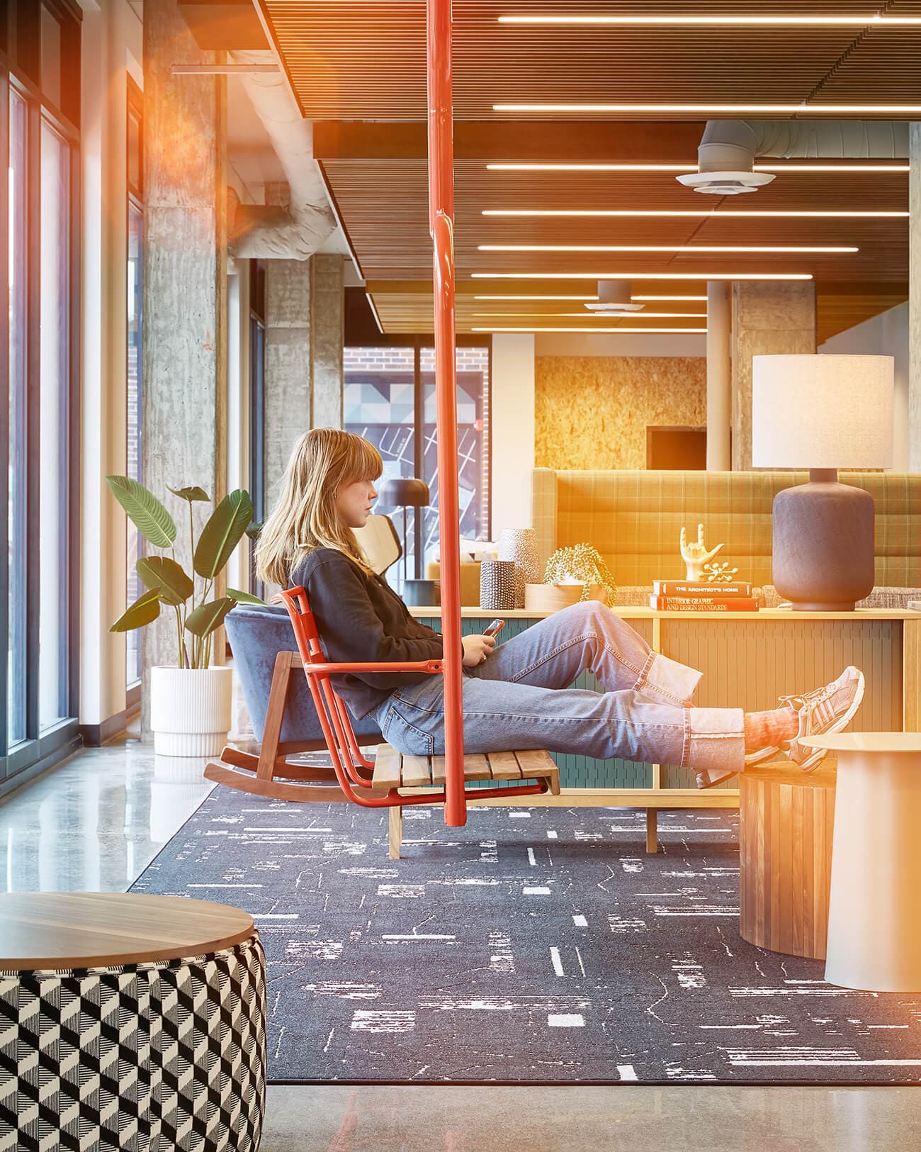 Person relaxing on a bench in the Stateside building lounge.