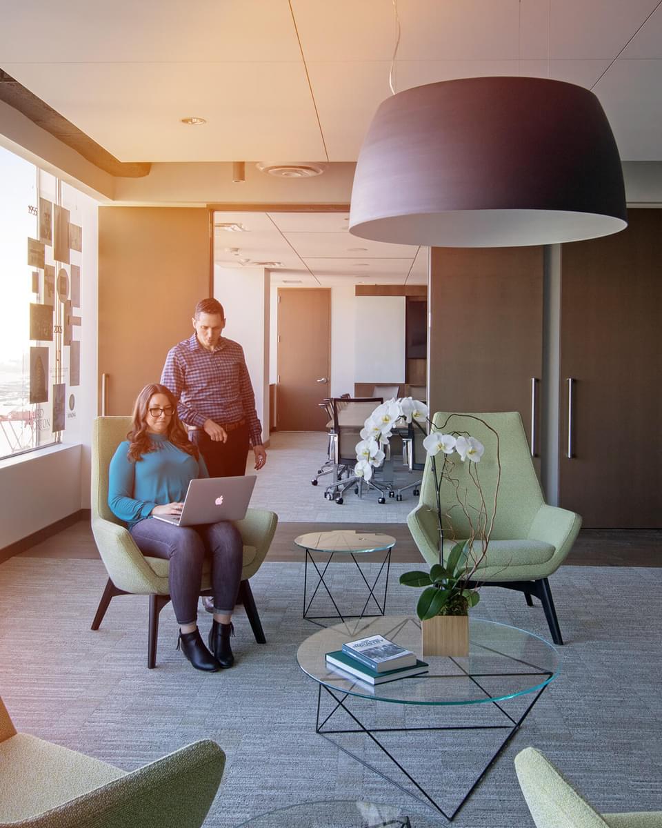 Two people talking in the lobby of the Laird Norton Company building.