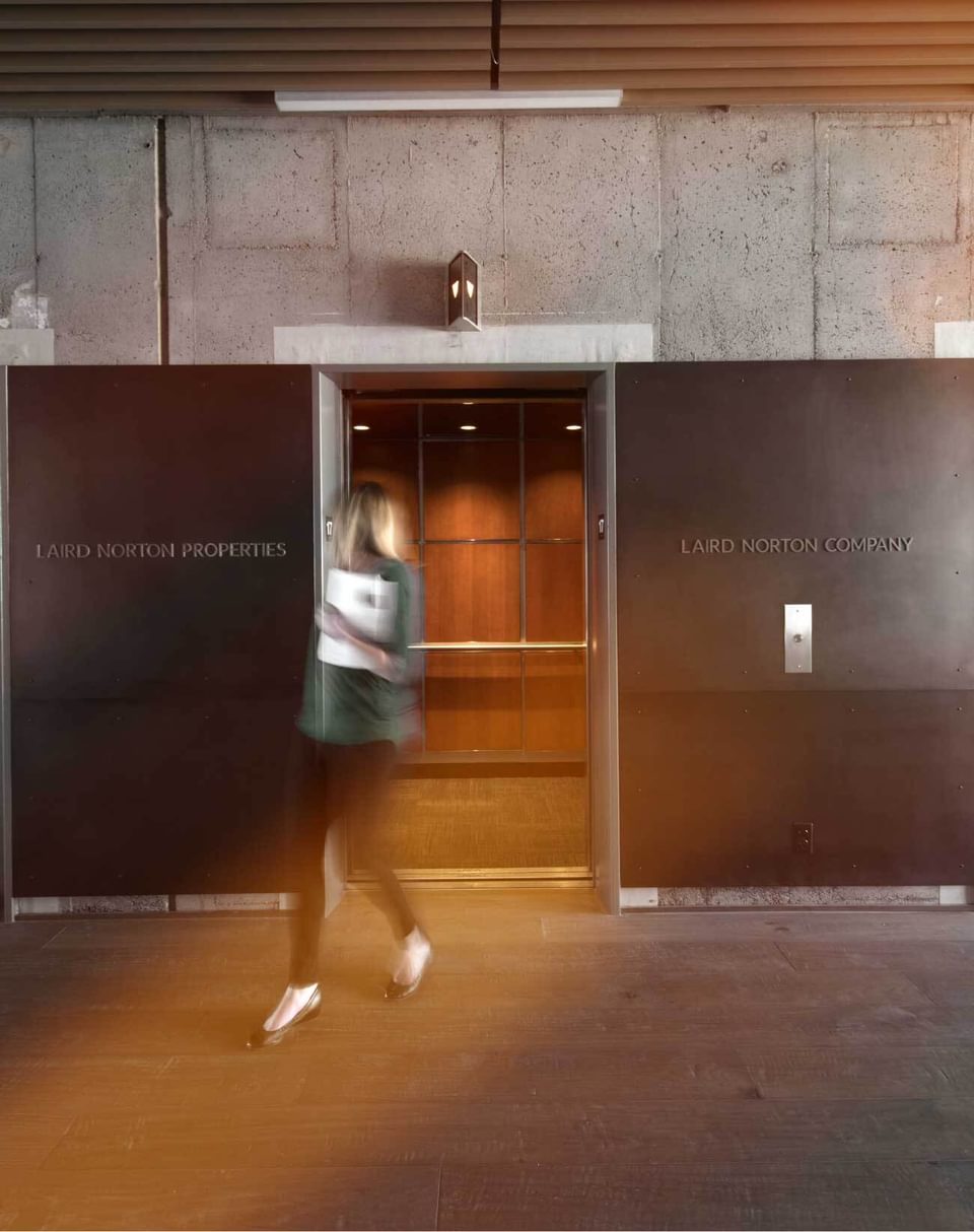 Employee walking through Laird Norton Company's office doors.